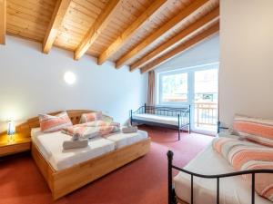 a bedroom with a bed and a couch in a room at Haus Anna in Längenfeld