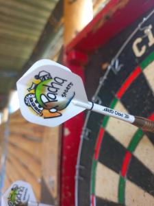 a dart board with a sticker on the dartboard at La Pacha Hostel in Barichara