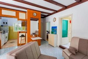 a living room with a couch and a kitchen at Vila Tamara Apartmani in Bečići