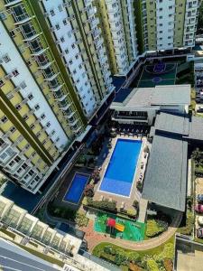 an overhead view of two large buildings with a swimming pool at Affordable staycation @Mesaverte Residences cdo in Cagayan de Oro