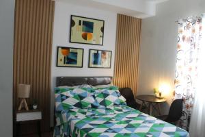 a bedroom with a bed and a table with chairs at Affordable staycation @Mesaverte Residences cdo in Cagayan de Oro +6 photos