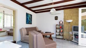 a living room with a couch and a table at Vila Tamara Apartmani in Bečići