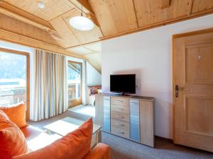 a living room with a tv on top of a dresser at Haus Anna in Längenfeld