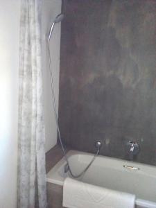 a bathroom with a bath tub with a shower curtain at Village Haven in Stanford