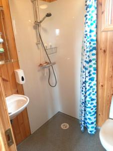 a bathroom with a sink and a shower at Lambhus Glacier View Cabins in Höfn