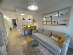 a living room with a couch and a table at Sea Esta Apartment in Nea Peramos