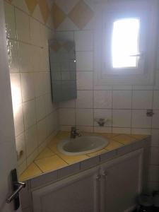 a bathroom with a sink and a window at Maisonnette in Montauroux