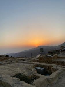 una puesta de sol en el cielo con la puesta de sol en la distancia en Dana Moon Hostel, en Dana