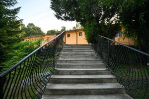 a stairway leading up to a building with a fence at Village of Peace - House 26 in Shkodër
