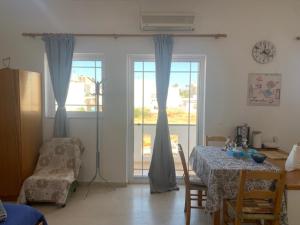 a dining room with a table and a window at Perivoli Guest Rooms in Kokkinos Pirgos