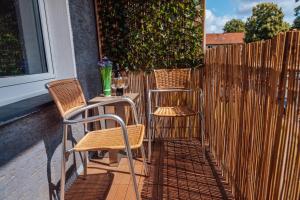 two chairs and a table next to a fence at Casa Melisa I 61m² I WLAN in Witten