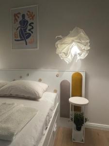 a bedroom with a bed and a light on the wall at Sea Esta Apartment in Nea Peramos