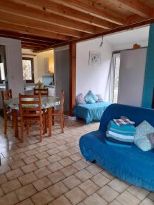 a living room with a blue couch and a table at Village de gites Lapeyre in Lapeyre