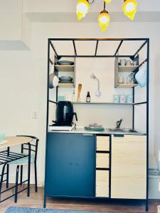 a kitchen with a blue counter and a table at Leiden City Centre Canal View or Terrace View Apartments in Leiden