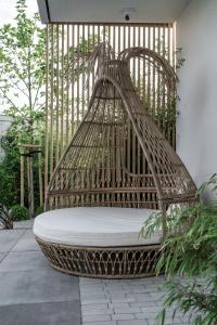 a wicker bench sitting on a patio at Rosa Style in Rowy
