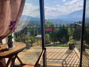 a balcony with a view of the mountains at The Mountain View in Peştera