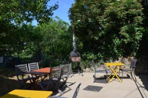 a group of tables and chairs and a fire place at les gites du passage: le nid in Passenans +5 photos