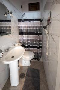 a white bathroom with a sink and a toilet at Casa el Mar apartamento Pescador in Lomo de Mena
