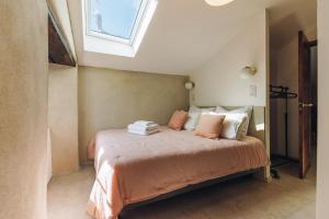 ein Schlafzimmer mit einem Bett mit Kissen und einem Fenster in der Unterkunft A Macina in Porri