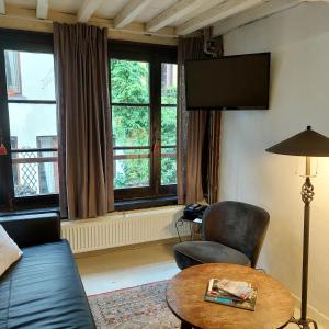 a living room with a couch and a chair and a table at Zuiderzin in Antwerp