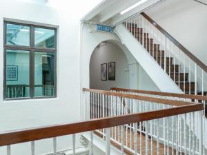 a staircase in a white building with a window at Aayu Chulia - Chulia St, George Town in George Town