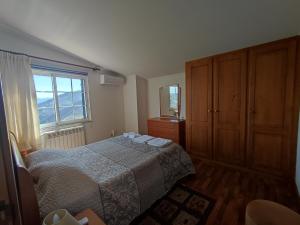 a bedroom with a bed and a dresser and a window at Encosta do Pinhão in Casal de Loivos