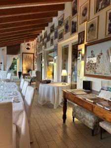 a dining room with a table and white chairs at Agriturismo Al Robale in Almenno San Bartolomeo