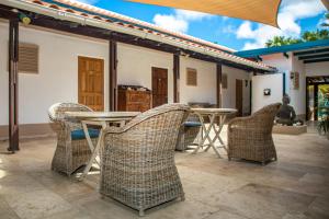 a group of chairs and tables on a patio at Bonaire 2 Stay Playa in Kralendijk