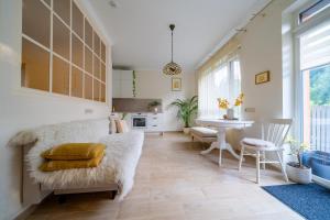 a living room with a couch and a table at Cozy apartment in Santariškės in Vilnius