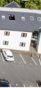 a white car parked in front of a building at Riverside apartments Westport in Westport