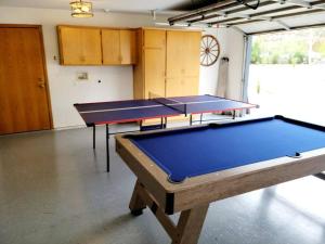two ping pong tables in a room at Oasis Riverfront House -10 min to Sequoia in Three Rivers