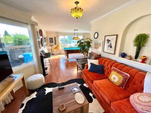 a living room with a couch and a table at Spacious Renovated Petaluma Home- Pool Table, Fire Pit, Parking in Petaluma
