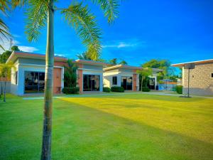 a palm tree in front of a house at The Memories Hill Phuket in Thalang