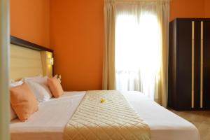 Postel nebo postele na pokoji v ubytování Hotel Rosignano