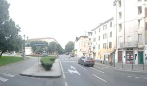 a car driving down a city street with buildings at Appartamento Tiffany in Brescia