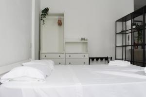 a bedroom with a large white bed with white pillows at Appartamento Tiffany in Brescia