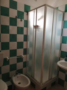 a bathroom with a shower and a toilet and a sink at Casa Fenice in Marinella di Selinunte