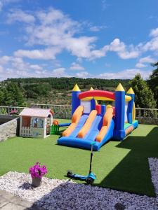 a playground with a play equipment on a lawn at Quinta da Telheira in Vila Real