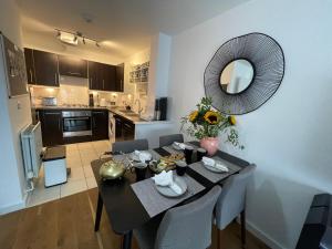 a dining room with a table and a mirror at Peloton Organic Health Apartment in Angel, Old Street, Islington in London