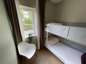 a room with two bunk beds and a window at The Hedge Apartments in Oslo