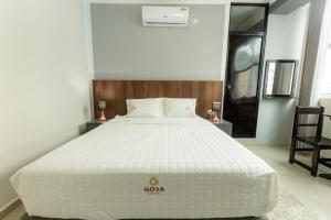 Ένα ή περισσότερα κρεβάτια σε δωμάτιο στο GOYA HOTEL