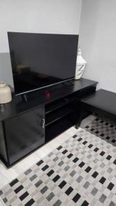 a black desk with a television on top of it at Tranquility on St James in Johannesburg