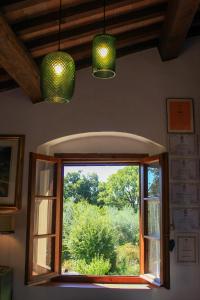 una finestra in una stanza con due luci verdi di AU-RA Vegan B&B a Castagneto Carducci