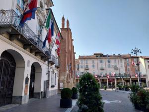 a street in a city with buildings and a christmas tree at Casa Cozy - Comodo Appartamento in Asti Centro in Asti +7 photos