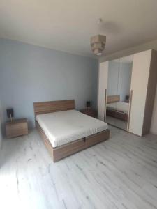 a bedroom with a large bed and a mirror at Angela in Garessio
