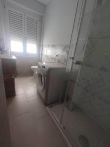 a bathroom with a washing machine and a shower at Angela in Garessio