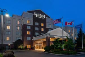 a hotel with two flags in front of it at Fairfield Inn & Suites – Buffalo Airport in Cheektowaga