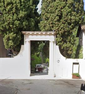 a white archway with a car driving through it at Cavour Apartment Center Bardolino in Bardolino +24 photos