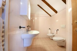 ein Bad mit einem WC, einem Waschbecken und einem WC in der Unterkunft Hotel Internazionale in Domodossola