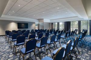 a conference room with chairs and a flat screen tv at Courtyard by Marriott Austin Dripping Springs in Dripping Springs
